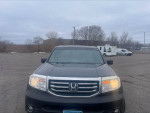 Front view of a 2014 Honda Pilot EX-L for sale, featuring fog lights and a silver grille.