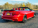 Red 2015 BMW M4 Convertible with 700+ horsepower, showcasing sleek design and alloy wheels in excellent condition.