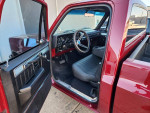 Interior view of a fully restored 1981 Chevy C10 pickup truck with modern features and digital gauges.
