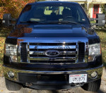 Black 2013 Ford F150 XLT with chrome grille and Southern body, 127,600 miles, parked in autumn setting