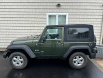2007 Jeep Wrangler Sport in excellent condition with new tires and features, parked outside a home.