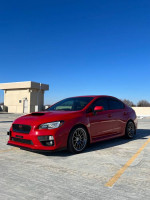 2016 Subaru WRX Limited in red parked on rooftop with clear blue sky