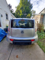Rear view of a 2011 Kia Soul parked outside, showcasing its sleek design and surroundings.