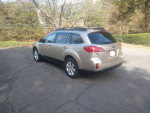 2010 Subaru Legacy Outback in excellent condition with all-wheel drive parked on a tree-lined street.