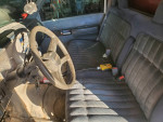 Interior of a 1993 GMC C3500 truck, featuring a steering wheel and fabric seats.