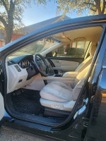 Interior view of a 2007 Mazda CX 9 Sport SUV with beige seats and dashboard details.