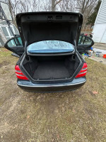 Open trunk of a Mercedes-Benz with clean interior and ample space for storage