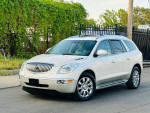 2011 Buick Enclave CXL2 FWD in silver with chrome wheels, parked in a scenic outdoor setting.