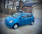 2015 Mitsubishi Mirage in blue, low mileage, parked in driveway, with minimal hail damage.