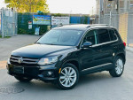 2012 Volkswagen Tiguan SE 4Motion in black, featuring alloy wheels and a clean exterior, ideal for family adventures
