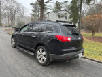 2009 Chevrolet Traverse LTZ FWD parked on street, showcasing sleek design and clean condition.