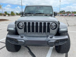 Front view of a customized 2019 Jeep Wrangler Unlimited Moab with aggressive tires and bold design.
