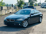 2015 BMW 5 Series 528i in black, showcasing excellent condition with leather seats and modern features