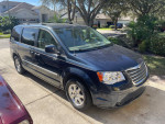 2009 Chrysler Town & Country minivan in good condition with stow and go seating, parked in a driveway