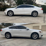 2016 Chevrolet Impala LT white sedan with a clean title and low mileage parked outdoors
