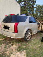 2007 Cadillac SRX parked outdoors with a partially open door, third row seating available.