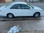 2006 Toyota Camry LE in white, reliable with aftermarket sound system for sale, 119,000 miles.