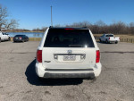 Rear view of a 2005 Honda Pilot 4WD with a clean Texas title, parked by a lake.