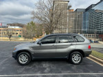 2006 BMW X5 3.0i AWD in grey, fully loaded with navigation and heated seats parked outside.