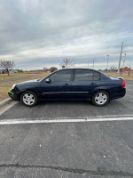 2006 Chevy Malibu LT blue car parked, low mileage, automatic starter, clean interior, minor front bumper damage.