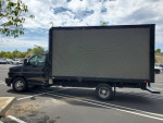 2018 Chevrolet Express cutaway truck with LED digital advertising billboard parked in a lot