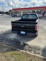 2010 Ford F-150 Supercrew V8 in good condition with intermittent cylinder misfire issue parked at a gas station.