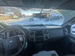 Interior view of a 2014 Ford F250 Super Duty pickup truck with 4WD, showing the dashboard and controls.