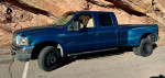 2001 Ford F350 Super Duty Crew Cab Dually in blue with low mileage, showcasing the exterior and rugged design.