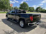 2021 GMC Sierra 1500 Denali 4WD in black, showcasing its sleek design and towing features.