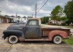 1950 GMC 100 Half Ton Step Side truck, suitable for restoration, parked on a street with cloudy sky.