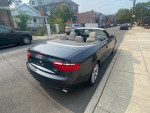 2008 Audi A5 convertible parked on the street, showcasing a sleek design and spacious interior.