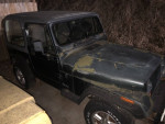1994 Jeep Wrangler in need of paint, featuring hard and soft tops, manual transmission, and excellent tires.