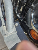 Detailed view of a modified 2012 Jeep Rubicon's front bumper with recovery gear and accessories.