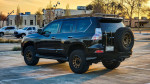 2016 Lexus GX 460 with off-road modifications parked at sunset, showcasing roof rack and spare tire carrier.