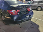 Damaged rear view of a 2009 Infiniti G37X AWD with new parts and tires for sale.