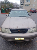 Front view of a 1998 Toyota Avalon XLS in need of minor repairs, showing rust spots and worn features.