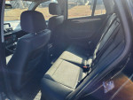 Interior view of a 2015 BMW X1 showing rear seats and dashboard features.