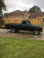 1973 Ford F-100 truck with rebuilt motor and custom features, parked on driveway.