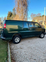 Green 2010 Chevrolet Express work van with 140,000 miles, good condition, keyless entry, and remote starter.