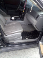 Interior view of a 2006 Jeep Cherokee Laredo with clean grey leather seats and dashboard.