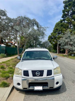 Front view of a Nissan Armada parked on the street, showcasing its good condition and spacious design.