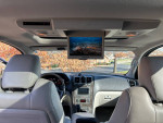 Interior view of 2012 GMC Acadia Denali featuring leather seats and an overhead DVD player.