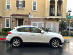 Side view of a 2008 Infiniti EX35 SUV parked in front of an apartment complex