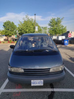 1993 Toyota Previa LE minivan parked, perfect for camping with mattress and storage for travel adventures.