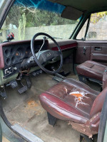 Interior view of a 1984 Chevrolet Blazer showing worn leather seats and dashboard, ideal for restoration enthusiasts.