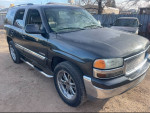 2004 GMC Yukon with 89,000 miles, black exterior, 20-inch rims, and leather interior for sale.