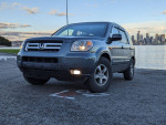 2006 Honda Pilot EX FWD in excellent condition near water with skyline in background