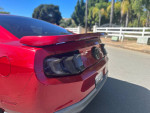 Rear view of a red 2010 Ford Mustang GT showcasing its sleek design and aftermarket features.