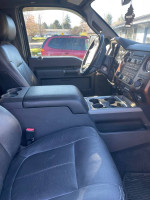 Interior view of a 2012 Ford F350 with black leather seats and modern dashboard features