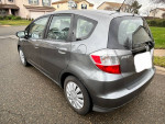 2013 Honda Fit in grey color, 80,000 miles, great gas mileage, parked on the street.